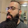a man with a long beard sticking his tongue out